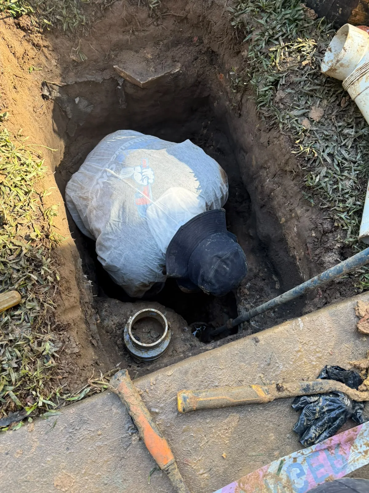 Excavating a blocked drain line in a side yard